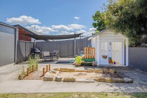 Kids will love the fun backyard replete with a cubby house and play equipment.
