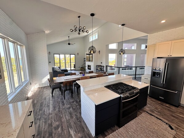 Kitchen, Dining, and living room that opens up to a beautiful patio lake view. 