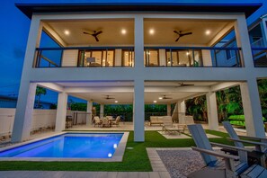 Sunset view of the home and private pool and lounge (1)
