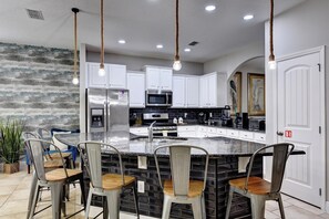 KITCHEN:  Fully Equipped Kitchen with Seating for 6 at Kitchen Island, Refrigerator, Microwave, Stove and Dishwasher