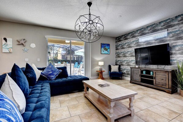 LEISURE ROOM:  Living Room Area with Sofa that seats between 4-5 people, 2 Accent Chairs and 65” Flat-Screen TV