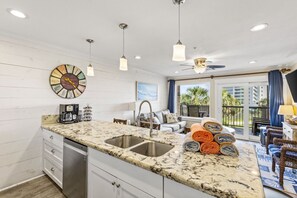 Inviting kitchen and living area with balcony access and scenic views