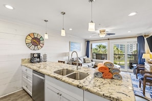 Inviting kitchen and living area with balcony access and scenic views