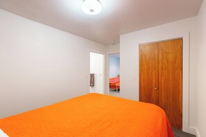 Second bedroom with queen-size bed and built-in closet space.