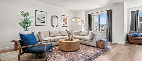 Lovely living room with modern decor and lovely mountain views.