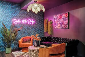 Step into the Speakeasy Lounge, a chic and cozy space perfect for unwinding in style.