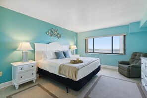 Comfortable master bedroom with a king-size bed and ocean views.