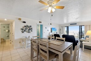 Dining area with seating for six, adjacent to the living room and ocean views.