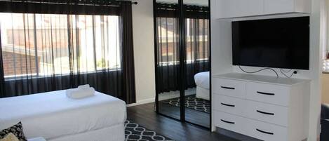 LIght filled studio room with plenty of storage, Large flat screen TV