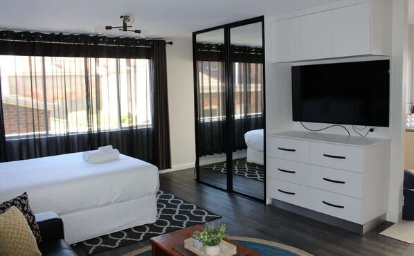 LIght filled studio room with plenty of storage, Large flat screen TV