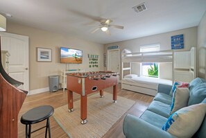 Game room with foosball, a sleep sofa, and a bunk bed.