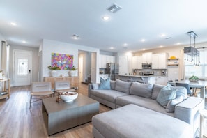 Living Area Features Sectional Seating, Flat Screen TV and Unique Décor