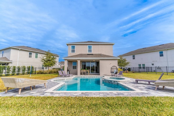 Lovely open back yard with green space, lounge area(s), private pool and spa!