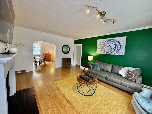 Fireplace in living room with large smart tv by our front entrance.