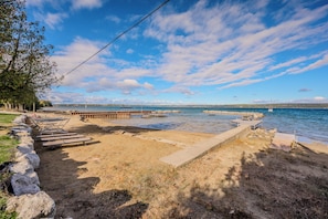 Guests enjoy shared access to the beach area, including dock. This is the perfect place to launch a kayak or boat, or simply enjoy the sandy beach for the day. 
