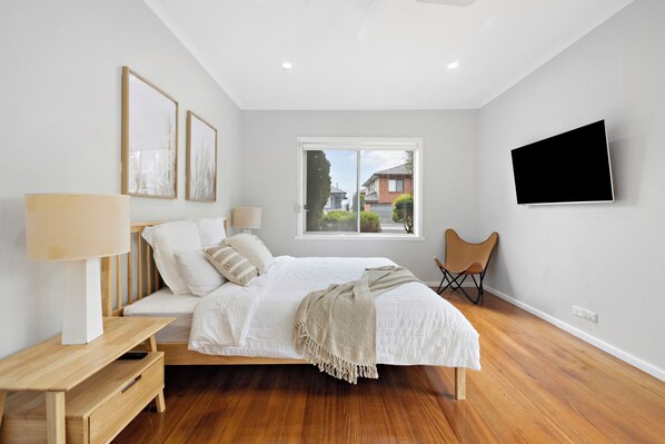 Bedroom 1 with King bed, ceiling fan, smart tv and wardrobe