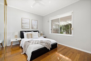 Bedroom 2 with queen bed, wardrobe and ceiling fan