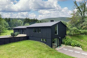Side view of the home with a scenic mountain backdrop