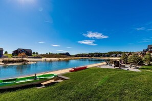 Backyard beach area with two kayaks and outdoor games/beach toys that we provide during your stay.
