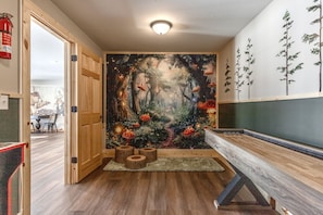 Take family photos in front of the enchanted forest wall mural, play paceman, shuffle board.  Have fun in the dark as well with the room outlined in black lights and glow in the dark features.