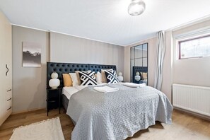 Our bedroom offers a cozy bed, providing a warm and inviting space for rest, complemented by a TV for your entertainment and relaxation.
