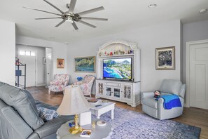 Cozy and spacious living area with TV