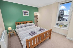 Master bedroom with a double bed, comfortable bedding, w/ fresh linens, and a beautiful view