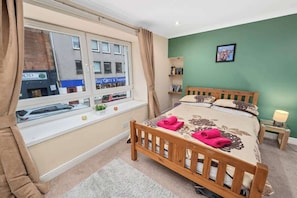 Master bedroom with a double bed, comfortable bedding, w/ fresh linens, and towels provided