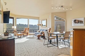 Bright open living space with sofa sleeper, gas fireplace, and Smart TV