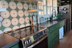 Designer kitchen with stylish cement tile and granite surfaces.