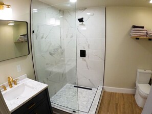 Full bathroom with tile/glass shower. Luxury glamping with all the comforts.
