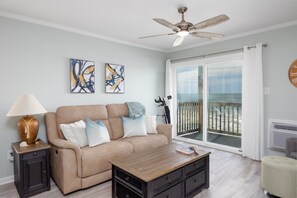 Comfy seating and sliding window with ocean views