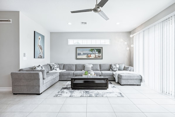 Unwind in this bright, open living room with a cozy sectional. Stream your favorites, relax, and bond with everyone in style.