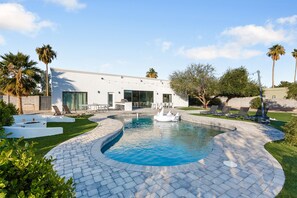 Giant Backyard featuring a pool, mini golf, cornhole, basketball court, sand volleyball, pickleball court, ping pong table, sun loungers, fire pit, grill, and dining table with seating for 10 guests.