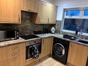 Bright kitchen , with dishwasher, washing machine , fridge/freezer and oven and hob 