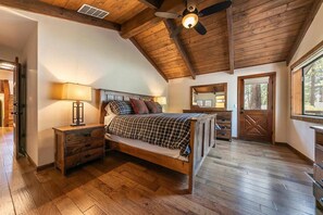Bedroom 1: Master bedroom, king bed, chair, 2 dressers, 65” Smart TV, en-suite bathroom, lower floor

