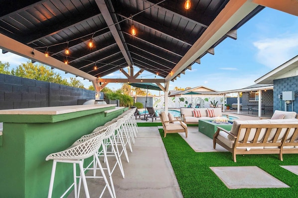 At the back, you'll find our outdoor bar with ample seating – the perfect place to sip cocktails and enjoy the great outdoors.
