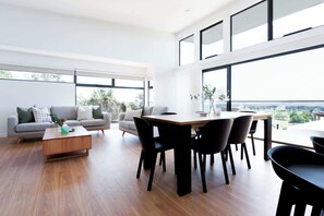 Gather around the spacious dining table with seating for 6, perfect for family meals or a catch-up with mates. The gorgeous wood floors add a warm touch, while the breathtaking view of nature outside makes every meal feel like a special occasion.