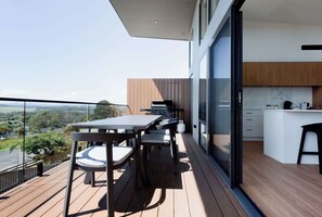 Step out onto the balcony with gorgeous wood floors, complete with a table and chairs, and soak in the stunning views. Once you're there, you won't want to leave – it's the perfect spot to relax and enjoy the scenery.