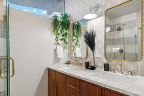 Enjoy the on-suite bathroom with a tiled shower and double vanity with a stone top - all completely remodeled in 2024.