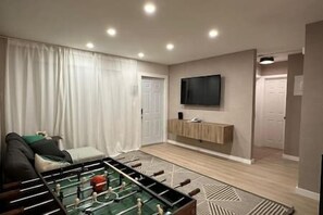 TV Room – Comfort and Entertainment! A cozy space to relax and enjoy your favorite movies and shows.