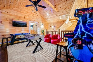 Game loft includes air hockey, foosball, Mortal Combat II, Pac Man, and a Smart TV.