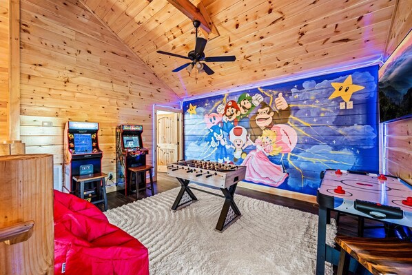 Game loft includes air hockey, foosball, Mortal Combat II, Pac Man, and a Smart TV.