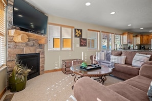 The open-concept living space, complete with a dining area, facilitates effortless conversation with family and friends.