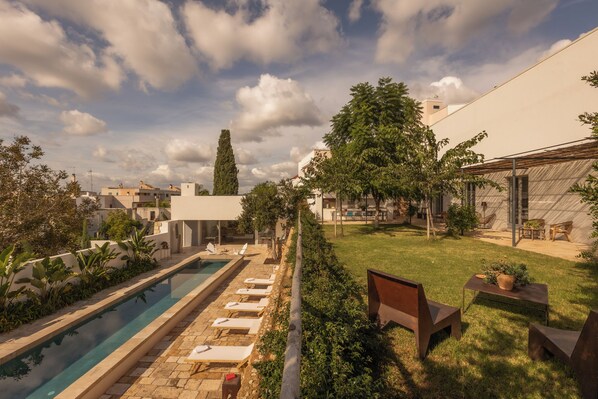 view of pool and garden