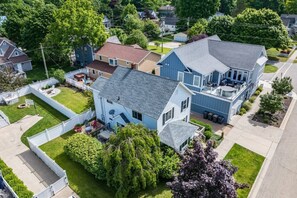 Take in the full charm of this spacious retreat from above, perfectly nestled just a block from Lake Michigan for easy access to the beach and nearby attractions.
