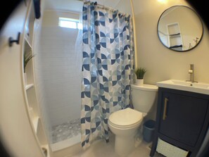 Newly remodeled bathroom with walk-in tile shower.