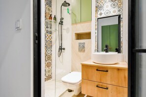 Refresh and recharge in a sleek, modern bathroom equipped with all essentials. Your Sofia retreat awaits—reserve today!