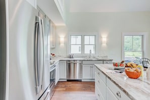 Modern kitchen with stainless appliances and granite countertops