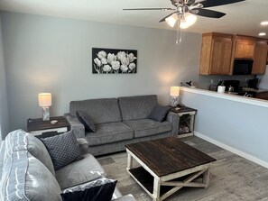 Enjoy relaxation with end tables for your drinks and a charging block.